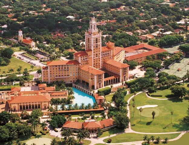 Aerial view of the Biltmore Hotel Coral Gables showing the historic Mediterranean Revival architecture, iconic tower, pool, and golf course.