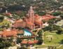 Aerial view of the Biltmore Hotel Coral Gables showing the historic Mediterranean Revival architecture, iconic tower, pool, and golf course.